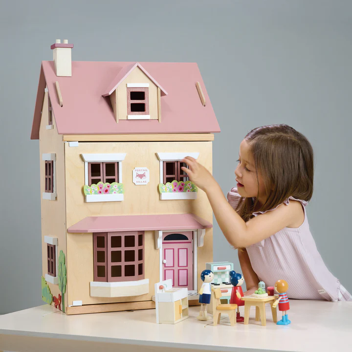 A child playing with a Tender Leaf Toys dolls house, a Rococo eCommerce client
